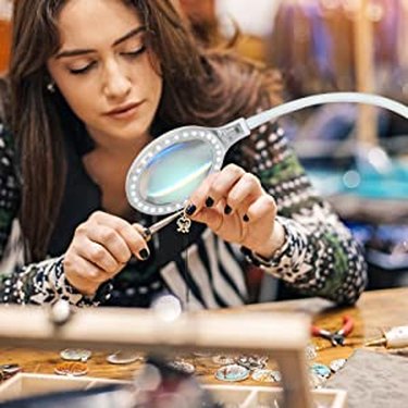 Woman Using a Brightech Magnifying Lamp to Make Jewelry