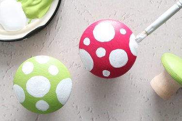 Paint white circles on top of the cabinet knobs