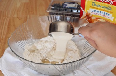 Adding sourdough discard to mixing bowl