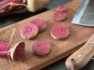 Sliced beets on a wooden cutting board