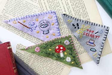 Three embroidered bookmarks