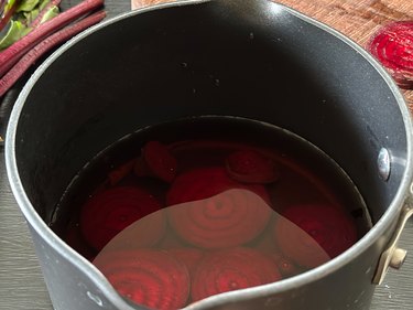 Sliced beets in water in a saucepan