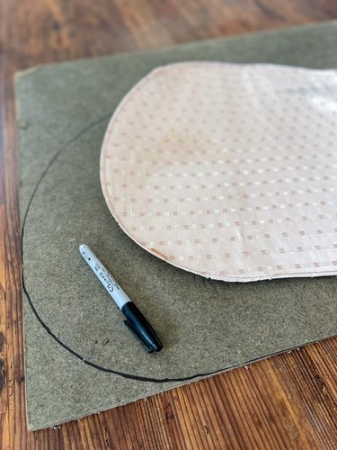 use bottom lining fabric as a pattern and trace onto masonite