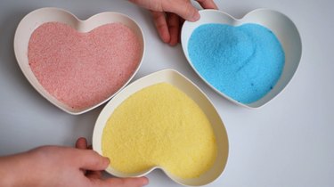 Colored sugars in pink, yellow, and blue