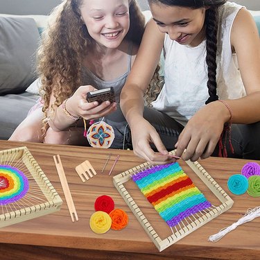 Two Girls Using a Coola Weaving Kit