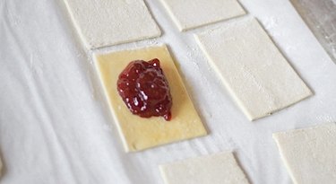 Egg-washed puff pastry with strawberry jam in the middle