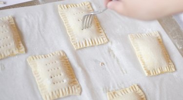 Poking holes on the tops of unbaked toaster tarts with a fork