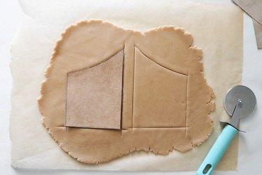 Cutting gingerbread cookie dough gates