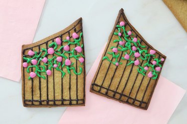 Gingerbread cookie dough gates with icing vines and roses