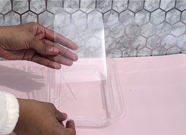 Removing piece from plastic lid