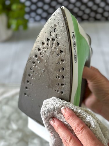 Pull iron out of ice cubes and wipe soleplate with a clean cloth