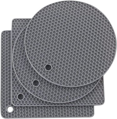 Set of four silicone grivets/heat pads, two round and two square, on a white ground