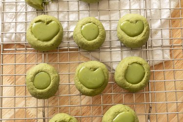 Matcha thumbprint cookies on a wire rack