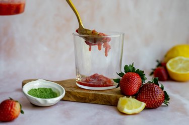 adding strawberry lemon mixture in a glass.