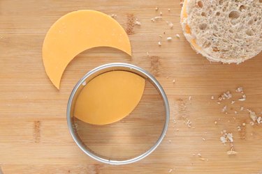 Cutting oval of cheese