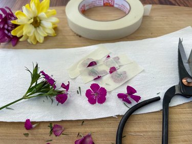 tape flowers to side pieces of hat