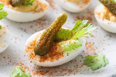 Bloody mary deviled eggs on plate
