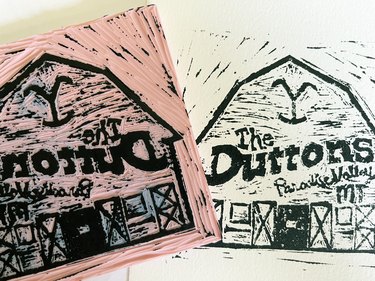 Inked rubber block next to test print of final stamp design