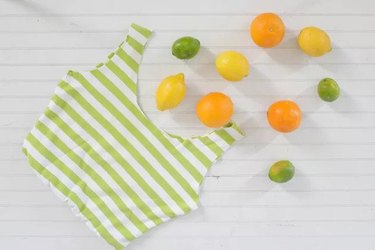 Green and white striped bag next to citrus fruits