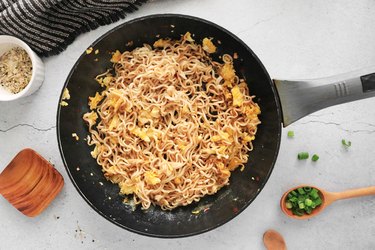 Toss scrambled eggs with noodles