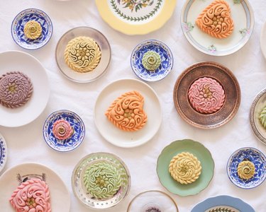 Small pastel-colored pastries featuring intricate designs