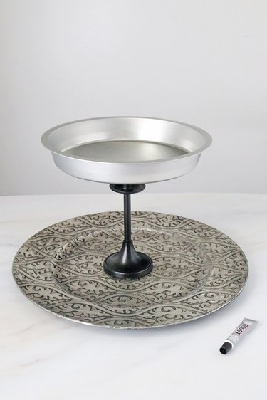 Candlestick glued to the center of a charger plate