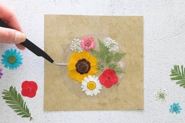 Add pressed flowers to plastic
