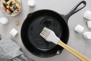 Coat mini cast iron pan with melted butter