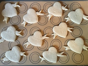 Plain heart-shaped sugar cookies on brown baking mat