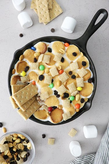 Campfire s'mores dip in a mini cast iron pan with graham crackers