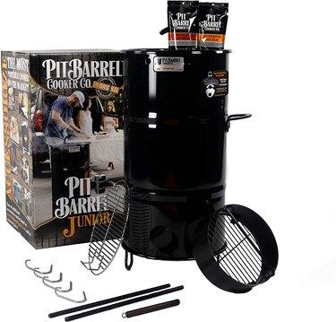 Pit Barrel Cooker Junior, displayed with retail box and accessories on a white ground