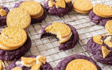 Ube golden Oreo with a bite taken out of it.