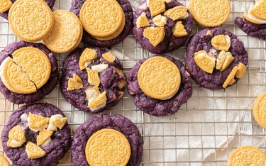 Ube golden Oreo cookies on a wire rack.
