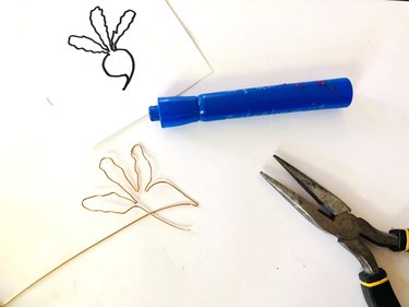 An image of wire shaped like a beet, pliers, a marker, and a drawing of a beet