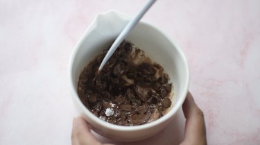 Melted chocolate and heavy cream in a bowl
