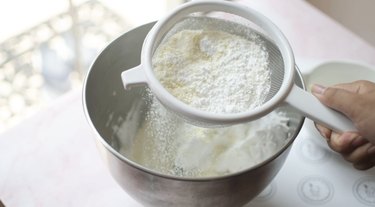 Sifting dry ingredients into meringue