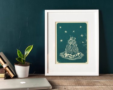 Framed print of green-and-white campfire against a green background