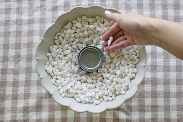 Adding small white pebbles around the rim of the fuel can