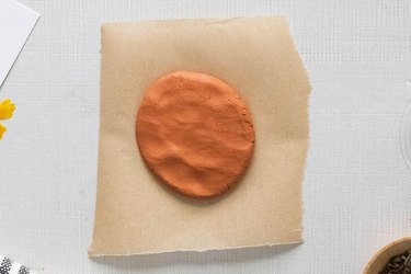 Clay disc on parchment paper