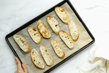 toasted crostinis on a baking sheet