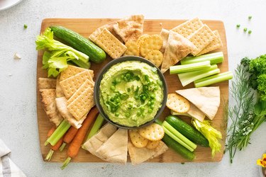 Spring hummus board with pita and crackers
