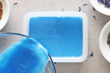 Pouring blue soap into a mold