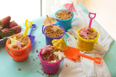 Beach buckets filled with cheesecake on a countertop