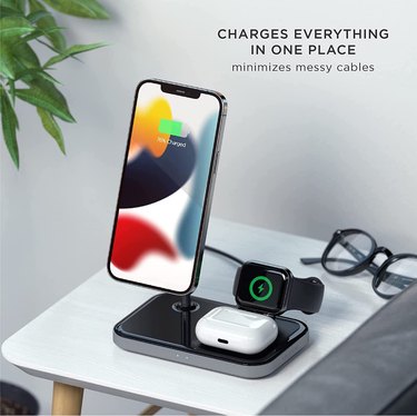 Satechi 3-in-1 Magnetic Wireless Charging Stand on side table next to houseplant.