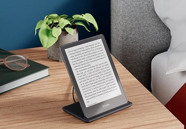 Amazon Kindle Paperwhite Signature Edition standing on nightstand.