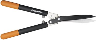 Fiskars 23-inch PowerGear Hedge Shears against a white background. The handles are quite long and the blades are silver and black.
