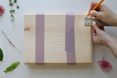 measuring and marking wood with a ruler and pencil