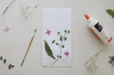 pressed florals glued to white paper bag