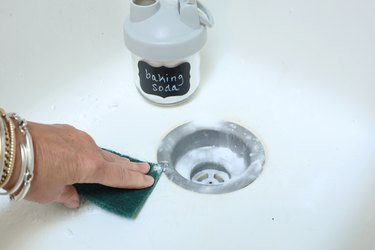 use baking soda to clean your kitchen sink and remove scratches