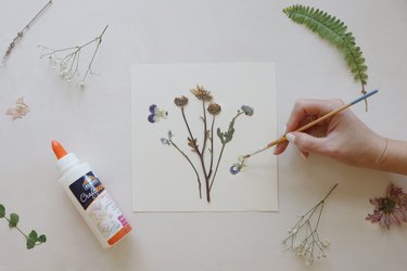 gluing pressed florals to card stock